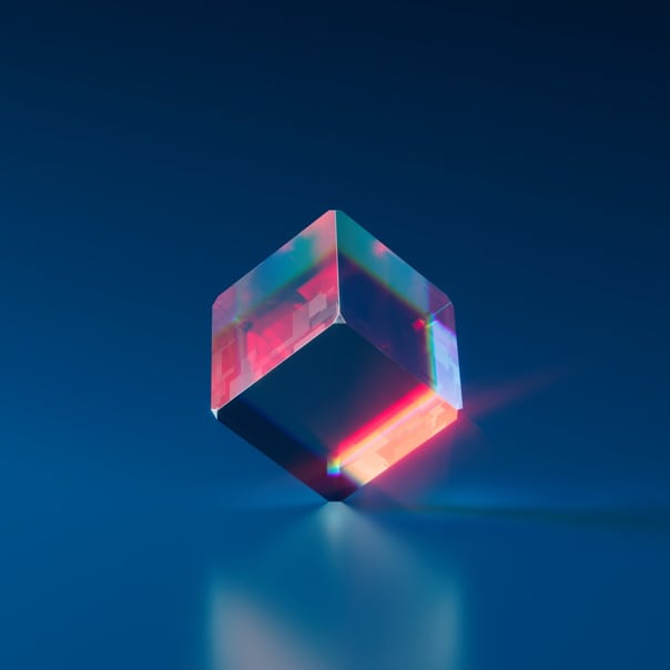 Crystal cube standing on one of it's corners on a dark blue background.